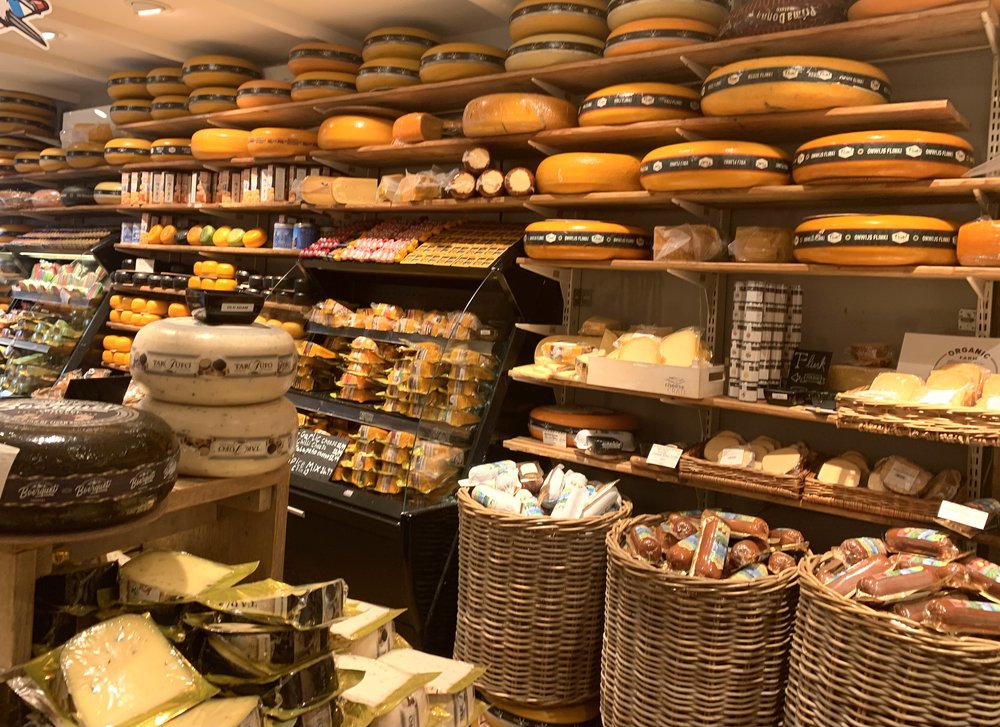 Fully stocked shelves of cheese at the Amsterdam Cheese Museum